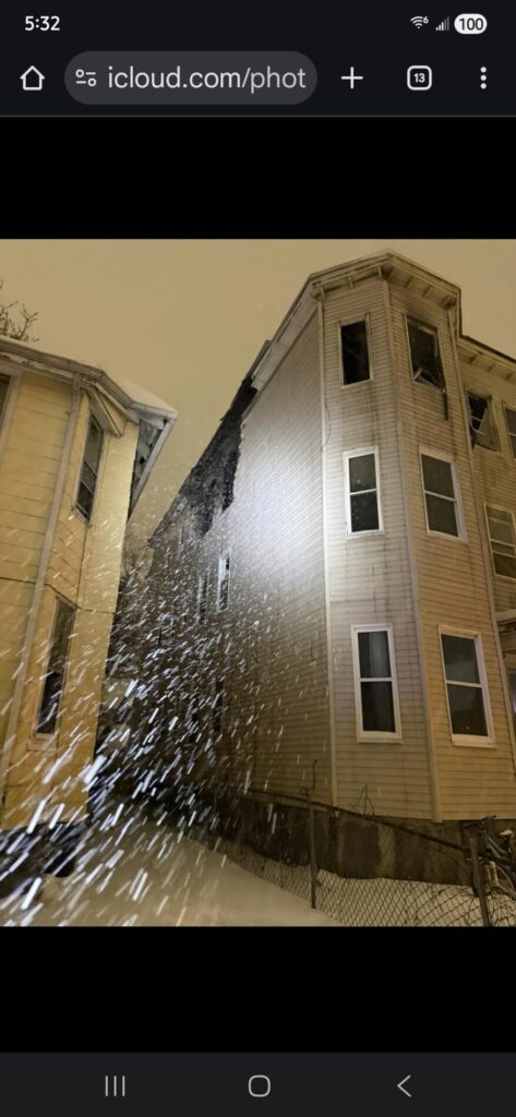 During a snowy night, fire damage to a tall apartment building